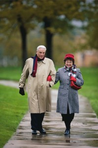 Elderly Couple Walking In The Rain