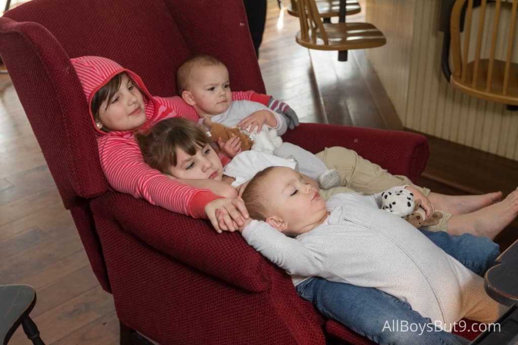 4 little girls sitting on a wingback chair