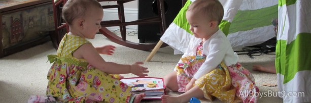 twin girls share quiet book during General Conference