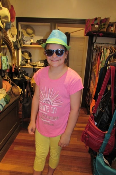 Esther shopping charming Cape May sporting sunglasses and a sun hat.