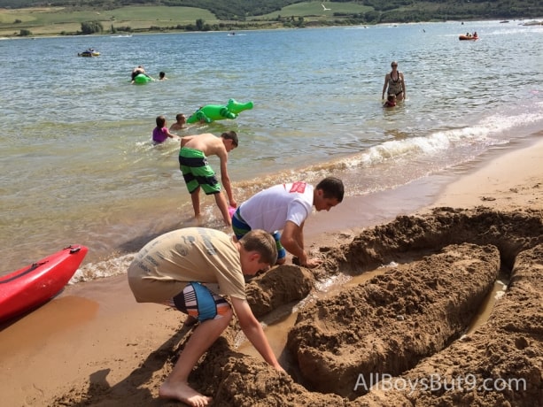 cousins dig a sand castle at the beach