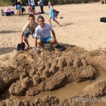 cousins create a sand castle
