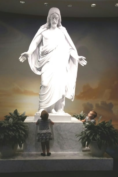 Addie and Sarah are captivated by the Christus statue in Washington DC temple visitor's center
